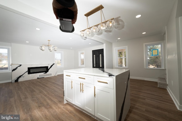 kitchen with a chandelier, white cabinets, dark wood finished floors, baseboards, and recessed lighting
