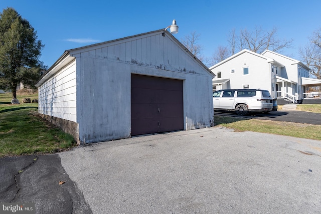 detached garage with asphalt driveway