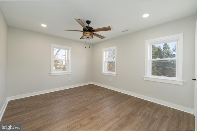 spare room featuring wood finished floors, baseboards, ceiling fan, and recessed lighting