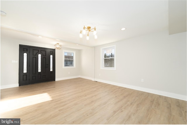 foyer with wood finished floors, baseboards, recessed lighting, and a chandelier
