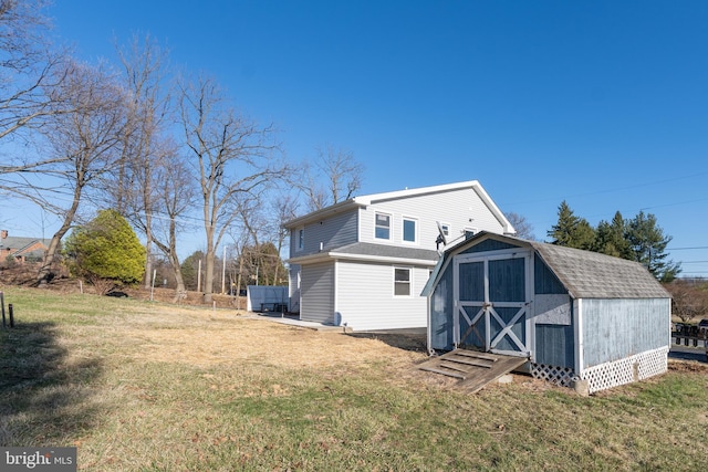 rear view of house featuring a yard