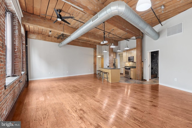 1147 N 4th St Unit 2E, Philadelphia, PA 19123 - unfurnished living room with light wood finished floors, a wooden ceiling with exposed beams, and ceiling fan
