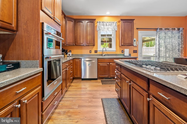 1209 Stevenage Ct, Abingdon, MD 21009 - kitchen with appliances with stainless steel finishes, light wood finished floors, recessed lighting, brown cabinetry, and a sink