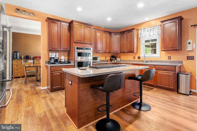 1209 Stevenage Ct, Abingdon, MD 21009 - kitchen with stainless steel appliances, a breakfast bar area, light wood-style flooring, a center island, and recessed lighting