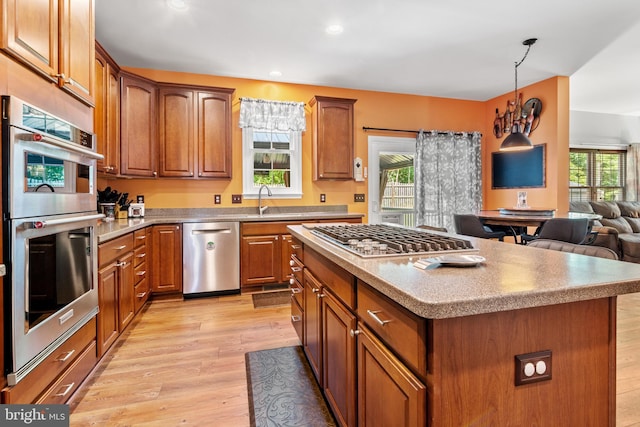 1209 Stevenage Ct, Abingdon, MD 21009 - kitchen with appliances with stainless steel finishes, light wood finished floors, brown cabinetry, a center island, and recessed lighting