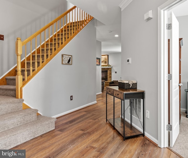 1209 Stevenage Ct, Abingdon, MD 21009 - stairway with a glass covered fireplace, wood-type flooring, baseboards, and recessed lighting