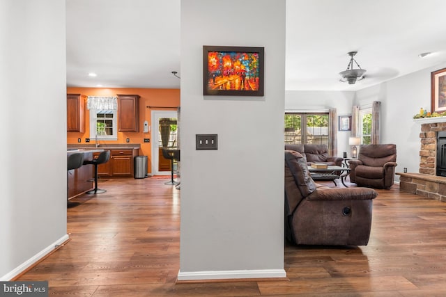 1209 Stevenage Ct, Abingdon, MD 21009 - living room featuring a stone fireplace, wood finished floors, recessed lighting, and baseboards