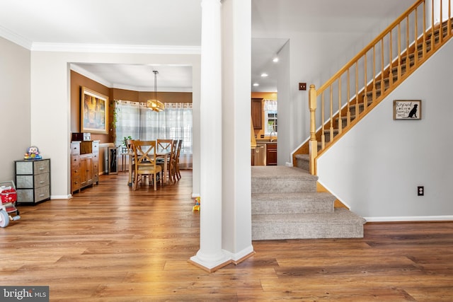1209 Stevenage Ct, Abingdon, MD 21009 - stairway featuring wood finished floors, ornamental molding, ornate columns, and baseboards