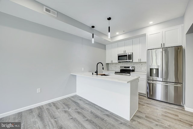 832 19th St NE Unit B, Washington, DC 20002 - kitchen with stainless steel appliances, decorative backsplash, light wood-style flooring, a peninsula, and recessed lighting
