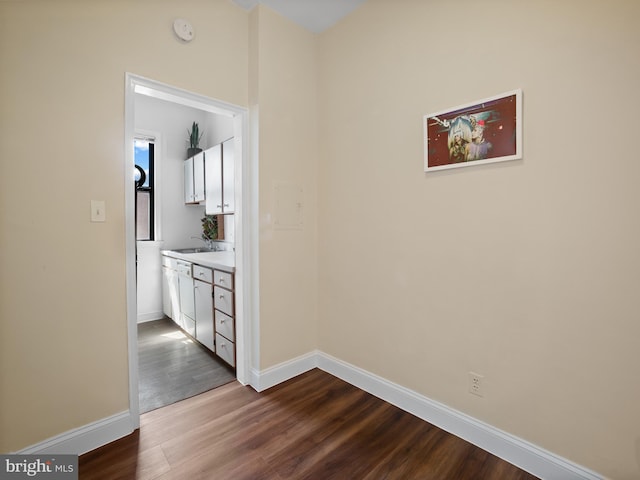 2515 K St NW Unit 807, Washington, DC 20037 - unfurnished dining area featuring dark wood-type flooring, a sink, and baseboards