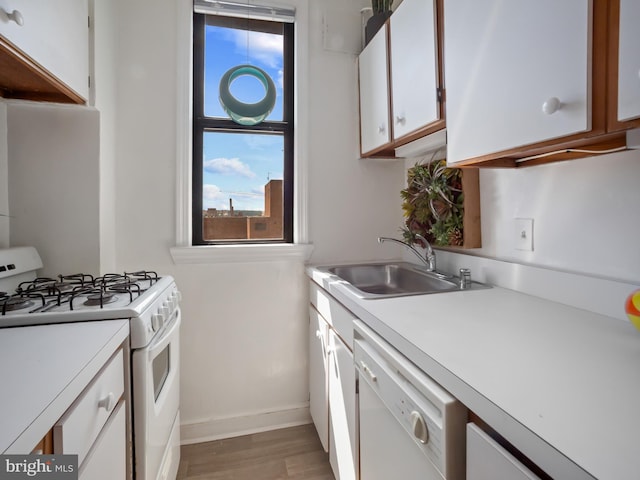 2515 K St NW Unit 807, Washington, DC 20037 - kitchen featuring white appliances, light countertops, white cabinetry, and a sink