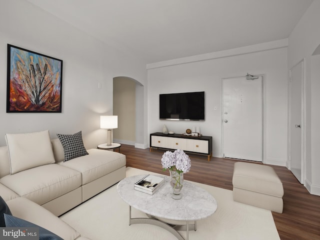 2515 K St NW Unit 807, Washington, DC 20037 - living room featuring arched walkways, wood finished floors, and baseboards