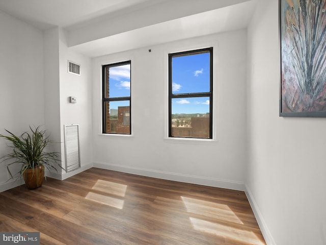 2515 K St NW Unit 807, Washington, DC 20037 - empty room with baseboards and wood finished floors