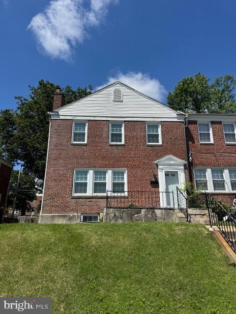 1811 Glen Ridge Rd, Towson, MD 21286 - view of front of house with a front lawn, a chimney, and brick siding