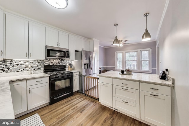 4208 Longfellow St, Hyattsville, MD 20781 - kitchen featuring appliances with stainless steel finishes, white cabinets, light wood finished floors, ceiling fan, and backsplash