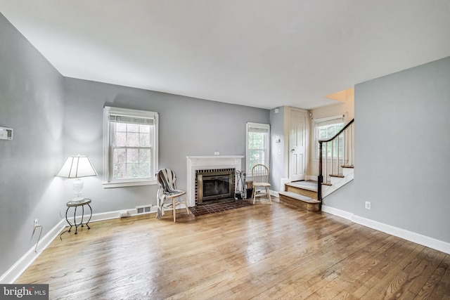 4208 Longfellow St, Hyattsville, MD 20781 - living area with wood-type flooring, stairs, and a brick fireplace