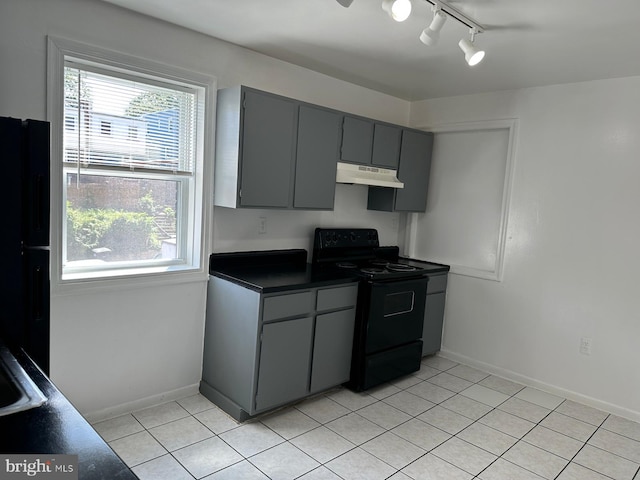 120 Danbury St SW Unit 120-C, Washington, DC 20032 - kitchen with black appliances, under cabinet range hood, dark countertops, rail lighting, and gray cabinets