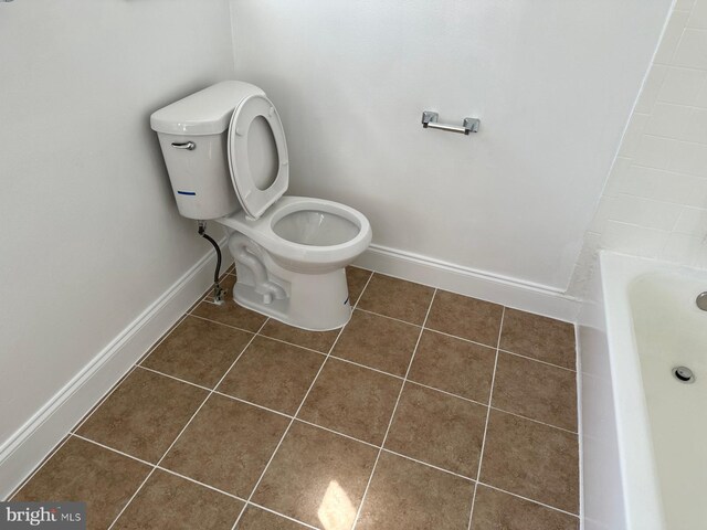 120 Danbury St SW Unit 120-C, Washington, DC 20032 - bathroom featuring tile patterned flooring, toilet, a tub, and baseboards