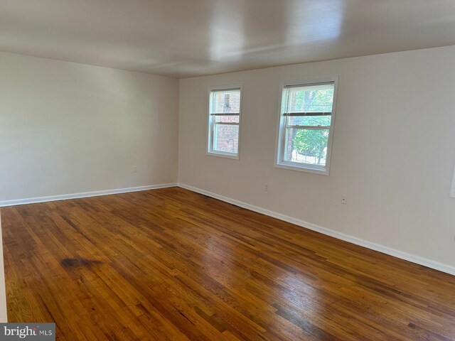 120 Danbury St SW Unit 120-C, Washington, DC 20032 - unfurnished room with dark wood-style flooring and baseboards