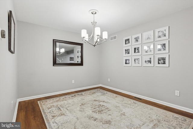 3708 Swetland Dr, Doylestown, PA 18902 - unfurnished room featuring dark wood-style flooring, a chandelier, and baseboards