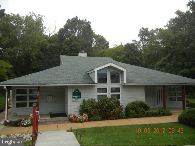 1414 Governor House Cir Unit 164, Wilmington, DE 19809 - view of front of house featuring covered porch, a chimney, roof with shingles, and view of scattered trees