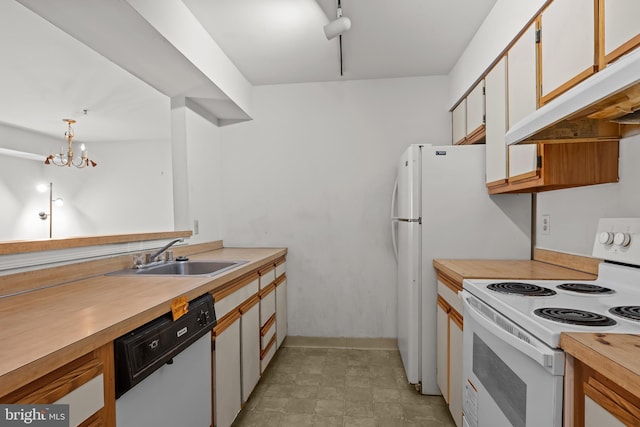 1414 Governor House Cir Unit 164, Wilmington, DE 19809 - kitchen with white appliances, under cabinet range hood, light countertops, a chandelier, and pendant lighting