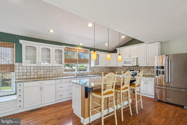 508 Weeks Ave, Riverside, NJ 08075 - kitchen featuring high end refrigerator, white microwave, glass insert cabinets, white cabinets, and vaulted ceiling