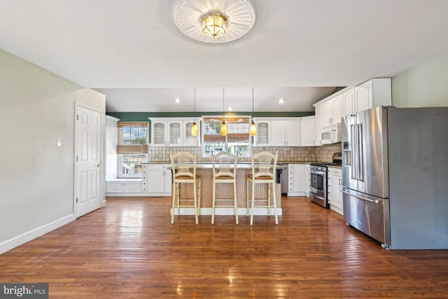 508 Weeks Ave, Riverside, NJ 08075 - kitchen featuring stainless steel appliances, a breakfast bar, glass insert cabinets, dark wood-style floors, and recessed lighting