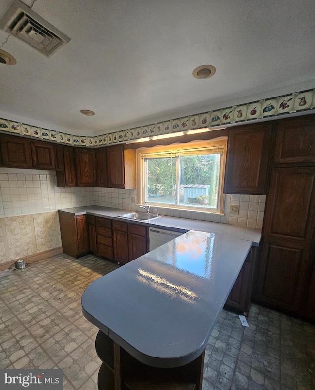 30292 Vines Creek Rd, Dagsboro, DE 19939 - kitchen with a sink, a peninsula, white dishwasher, tile patterned floors, and tasteful backsplash
