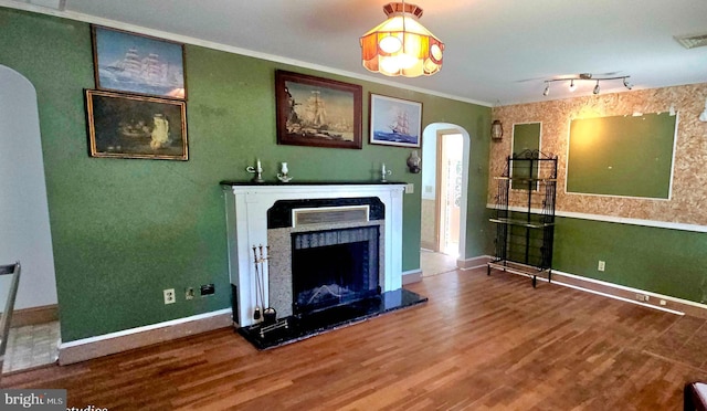 30292 Vines Creek Rd, Dagsboro, DE 19939 - unfurnished living room with arched walkways, wood finished floors, a fireplace with raised hearth, baseboards, and crown molding