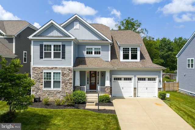 409 Pear Blossom Rd, Stafford, VA 22554 - craftsman-style house with board and batten siding, stone siding, driveway, and roof with shingles