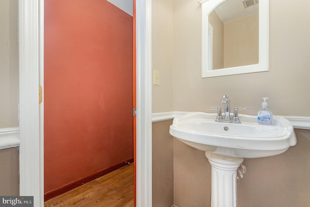 4210 Mcintosh Rd, Harrisburg, PA 17112 - bathroom featuring wood finished floors, a sink, and baseboards
