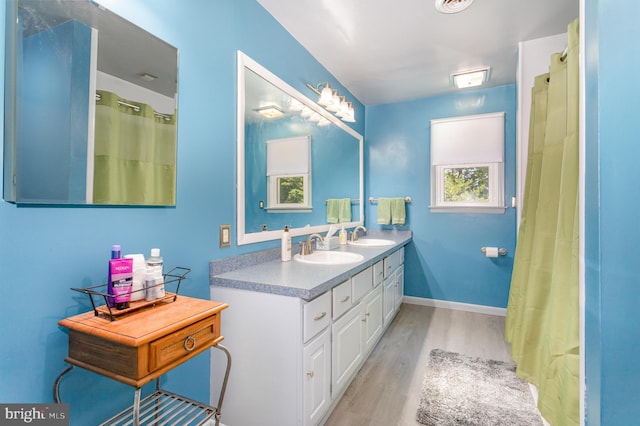 4210 Mcintosh Rd, Harrisburg, PA 17112 - full bath with wood finished floors, double vanity, baseboards, and a shower with curtain