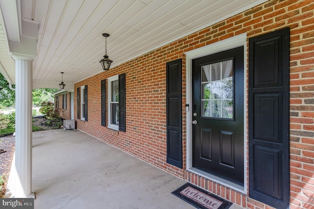 4210 Mcintosh Rd, Harrisburg, PA 17112 - view of exterior entry featuring covered porch and brick siding