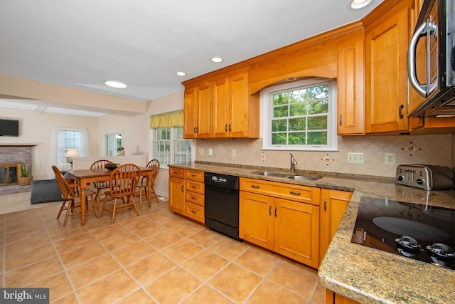 108 Holiday St, Mount Laurel, NJ 08054 - kitchen featuring black appliances, a sink, decorative backsplash, a brick fireplace, and light tile patterned flooring