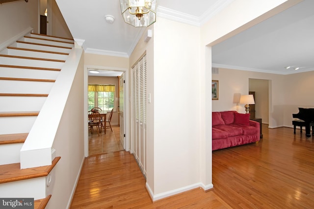 108 Holiday St, Mount Laurel, NJ 08054 - hallway featuring light wood-style flooring, crown molding, stairs, a chandelier, and baseboards