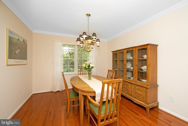 108 Holiday St, Mount Laurel, NJ 08054 - dining room with a chandelier, wood finished floors, crown molding, and baseboards