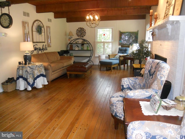 22 Hart Ln, Sewell, NJ 08080 - living room featuring hardwood / wood-style flooring, beamed ceiling, a chandelier, and a brick fireplace