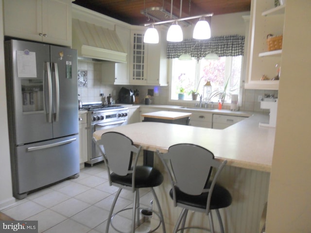 22 Hart Ln, Sewell, NJ 08080 - kitchen with stainless steel appliances, wall chimney exhaust hood, tasteful backsplash, and a kitchen bar