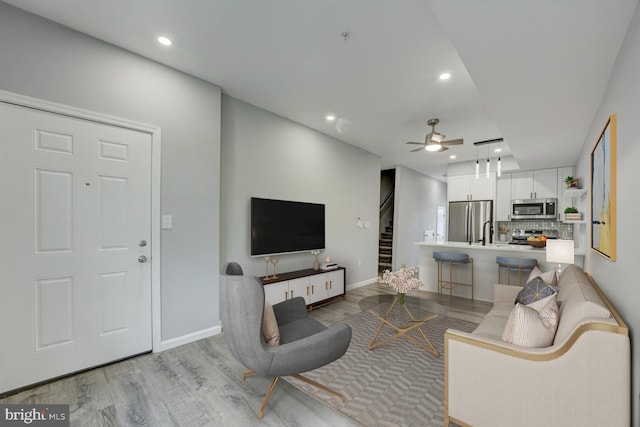 832 19th St NE Unit C, Washington, DC 20002 - living room featuring recessed lighting, stairway, light wood finished floors, ceiling fan, and baseboards