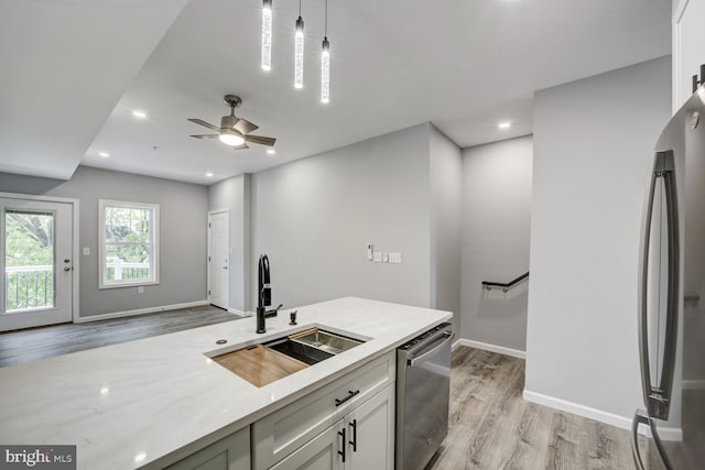 832 19th St NE Unit C, Washington, DC 20002 - kitchen featuring a sink, stainless steel dishwasher, light wood-style flooring, light countertops, and recessed lighting