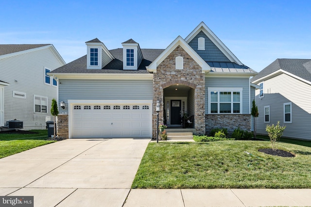 4387 Shakespeare Cir, White Plains, MD 20695 - craftsman-style house featuring stone siding, a front yard, concrete driveway, a garage, and cooling unit