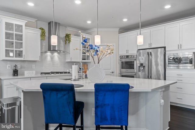 4387 Shakespeare Cir, White Plains, MD 20695 - kitchen with appliances with stainless steel finishes, wall chimney range hood, decorative backsplash, an island with sink, and a sink