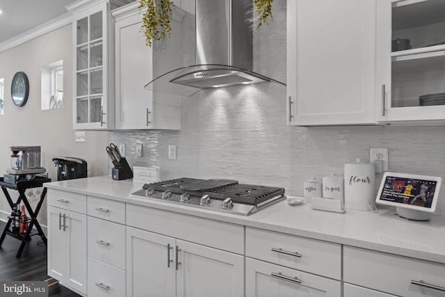 4387 Shakespeare Cir, White Plains, MD 20695 - kitchen with wall chimney range hood, stainless steel gas cooktop, dark wood-style floors, white cabinetry, and crown molding