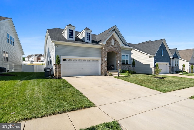 4387 Shakespeare Cir, White Plains, MD 20695 - view of front facade featuring concrete driveway, a front yard, an attached garage, and stone siding