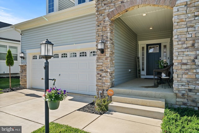 4387 Shakespeare Cir, White Plains, MD 20695 - view of exterior entry with concrete driveway and stone siding