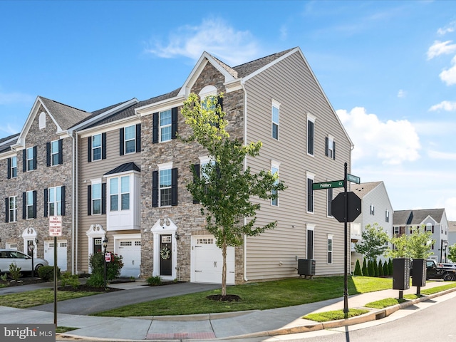 110 Fritillary Ct, Lake Frederick, VA 22630 - townhome / multi-family property with a garage, stone siding, central AC, a residential view, and driveway