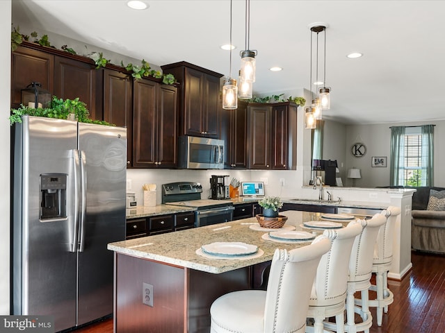110 Fritillary Ct, Lake Frederick, VA 22630 - kitchen featuring appliances with stainless steel finishes, a sink, dark brown cabinets, light stone countertops, and dark wood-style flooring