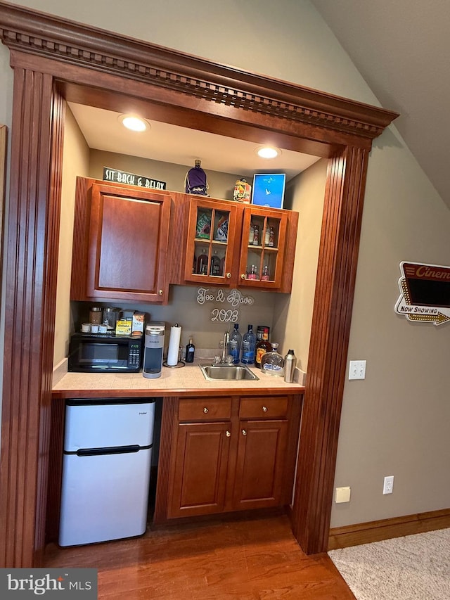 12534 Fawn Dr, Laurel, DE 19956 - kitchen with freestanding refrigerator, black microwave, brown cabinets, light countertops, and recessed lighting