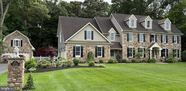 12534 Fawn Dr, Laurel, DE 19956 - view of front of house featuring stone siding, a front lawn, and roof with shingles
